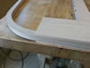 The headboard bow is glued to the two headboard posts before the posts are cut to shape.