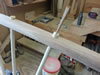 Spindles are glued and wedged in place and then cut and sanded flush.