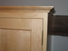 Top molding and narrow beveled panel doors in maple