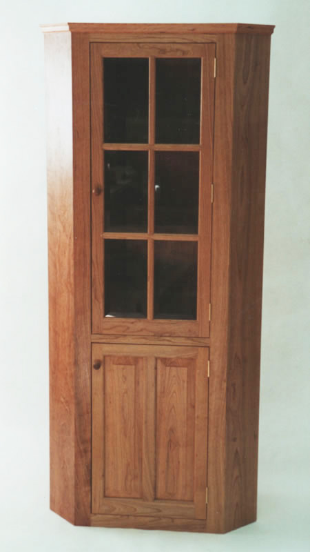 Cherry corner cabinet with beveled glass door. 74"h x 34"w x 24" to corner.