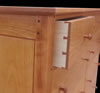 Dovetailed drawers. Mortise & tenon joinery pinned with walnut pegs. Beveled panel detail.