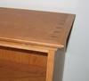Bookcase top is dovetailed to sides and wrapped with 1" cove molding