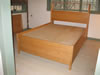 Custom oak bed with drawers and bookcase headboard