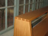 Dovetailed corner joint of oak bookcase headboard