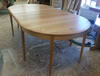 The table with no leaves in place is 94" (7'10") long and seats 10 comfortably.